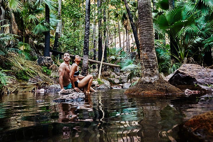 Couple enjoying the Zebedee Springs, El Questro Wilderness Park
