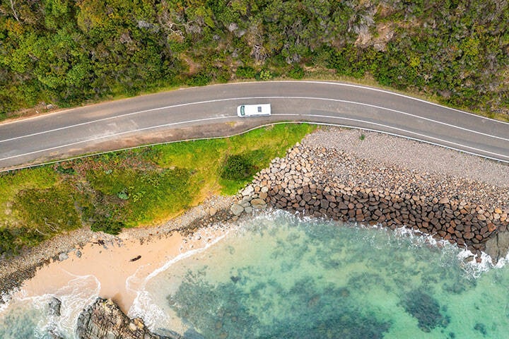 Aerial view of car driving along the great ocean road