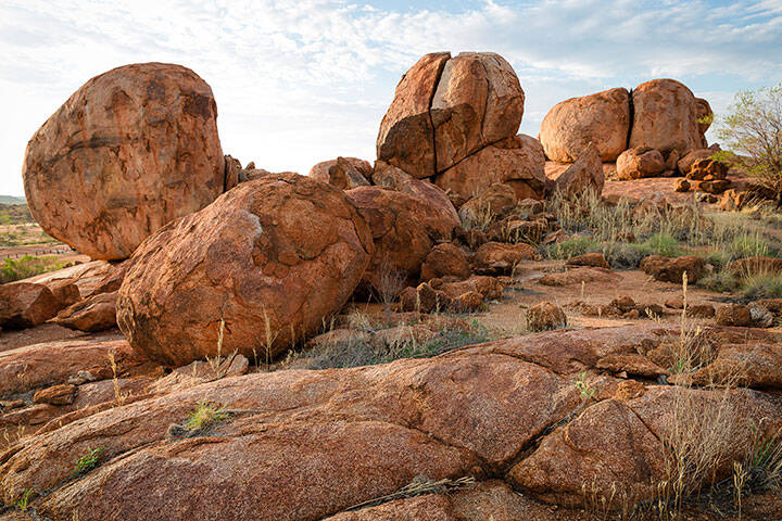 Karlu Karlu/Devils Marbles - The Devils Marbles are a collection of massive granite boulders strewn across a valley south of Tennant Creek. Standing at up to 6 metres high and formed over millions of years, they continue to crack and change.