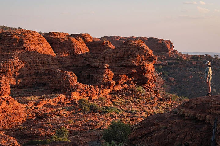 Exploring the red rock cliffs of Kings Canyon in Watarrka National Park, 3 hours from Uluru