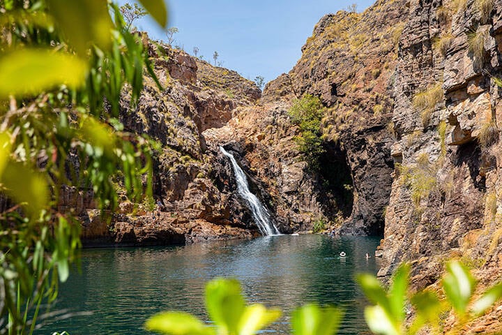 Exploring Maguk Waterfall in Kakadu. Maguk is a pristine natural waterfall and plunge pool at the base of steep gorge walls. 
