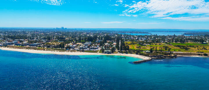 Aerial view of Cottesloe Beach showing Perth city and the Swan River in the distance. 