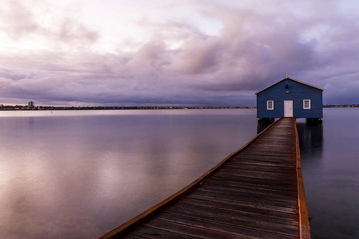 Blue boat shed on a rainy morning on the Swan River in Perth, Western Australia