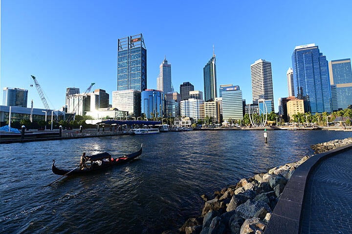 Gondolla boat sailing into Elizabeth Quay in Perth at sunset 
