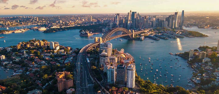 Aerial drone view of Sydney City and Sydney Harbour showing Sydney Harbour Bridge and Lavender Bay in the late afternoon 