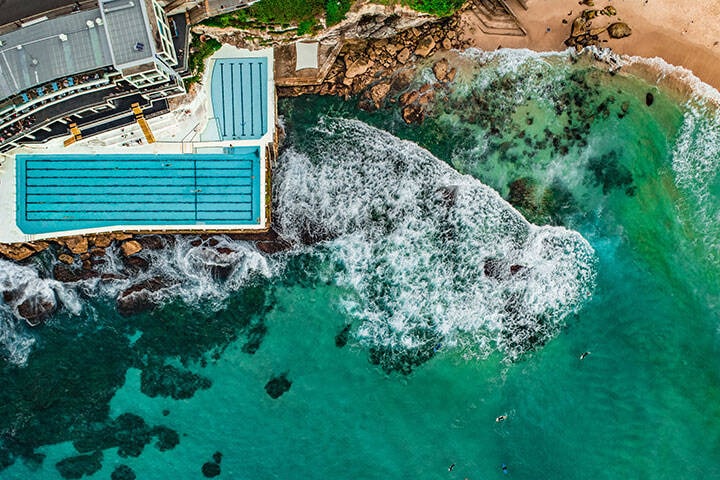 Aerial Drone shot of Waves crashing on to Bondi Icebergs Rockpool 