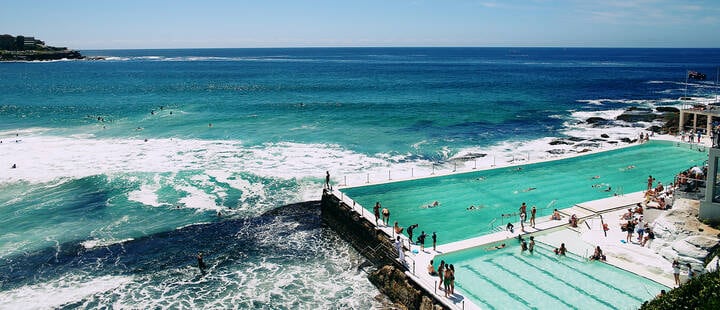 Swimmers at Bondi Icebergs on a clear, sunny day.
