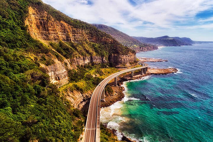 Aerial drone view of Breakwater Lighthouse toward Continental Pool at Wollongong on the New South Wales South Coast, Australia showing the breakwater structure and boat moorings on a sunny day