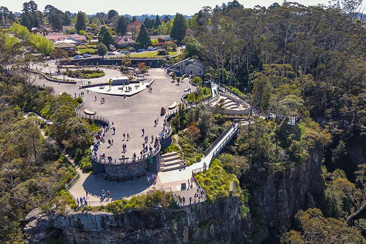 Aerial drone view of Breakwater Lighthouse toward Continental Pool at Wollongong on the New South Wales South Coast, Australia showing the breakwater structure and boat moorings on a sunny day