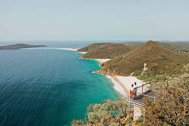 Couple enjoying the coastal views along Tomaree Head Summit Walk, Port Stephens.