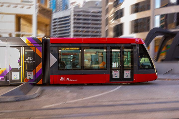 Tram moving through George street in heart of Sydney CBD NSW Australia