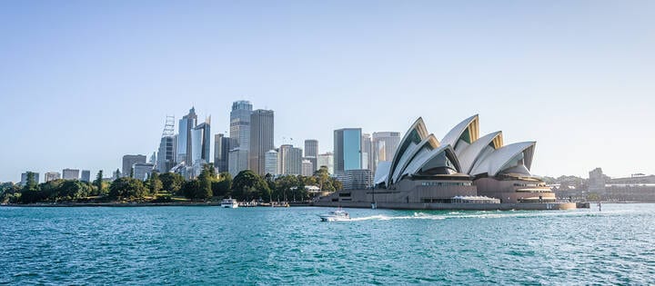 Beautiful sunny day on Sydney Harbour, with a view from the water of the  city skyline, Opera House and Circular Quay on a bright, warm day  