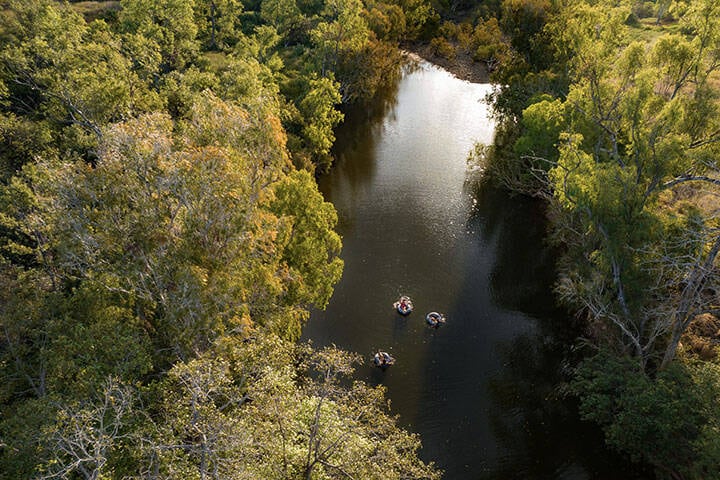 Family floating in the waters of the weir at Mount Mulligan