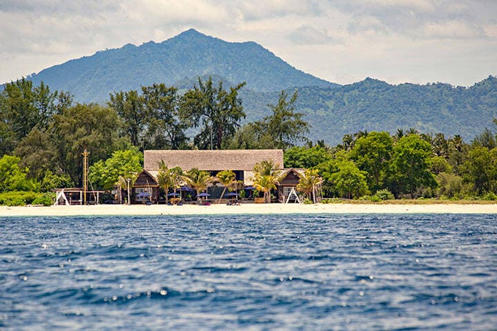 White sand beach and boats in the water on the beautiful Gili Meno island, Bali, Indonesia 