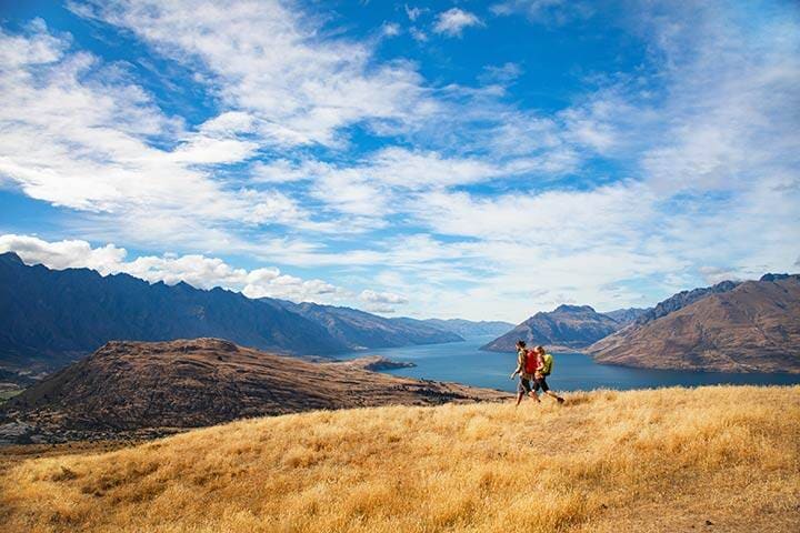 Couple on hiking holiday New Zealand Lake Wakatipu