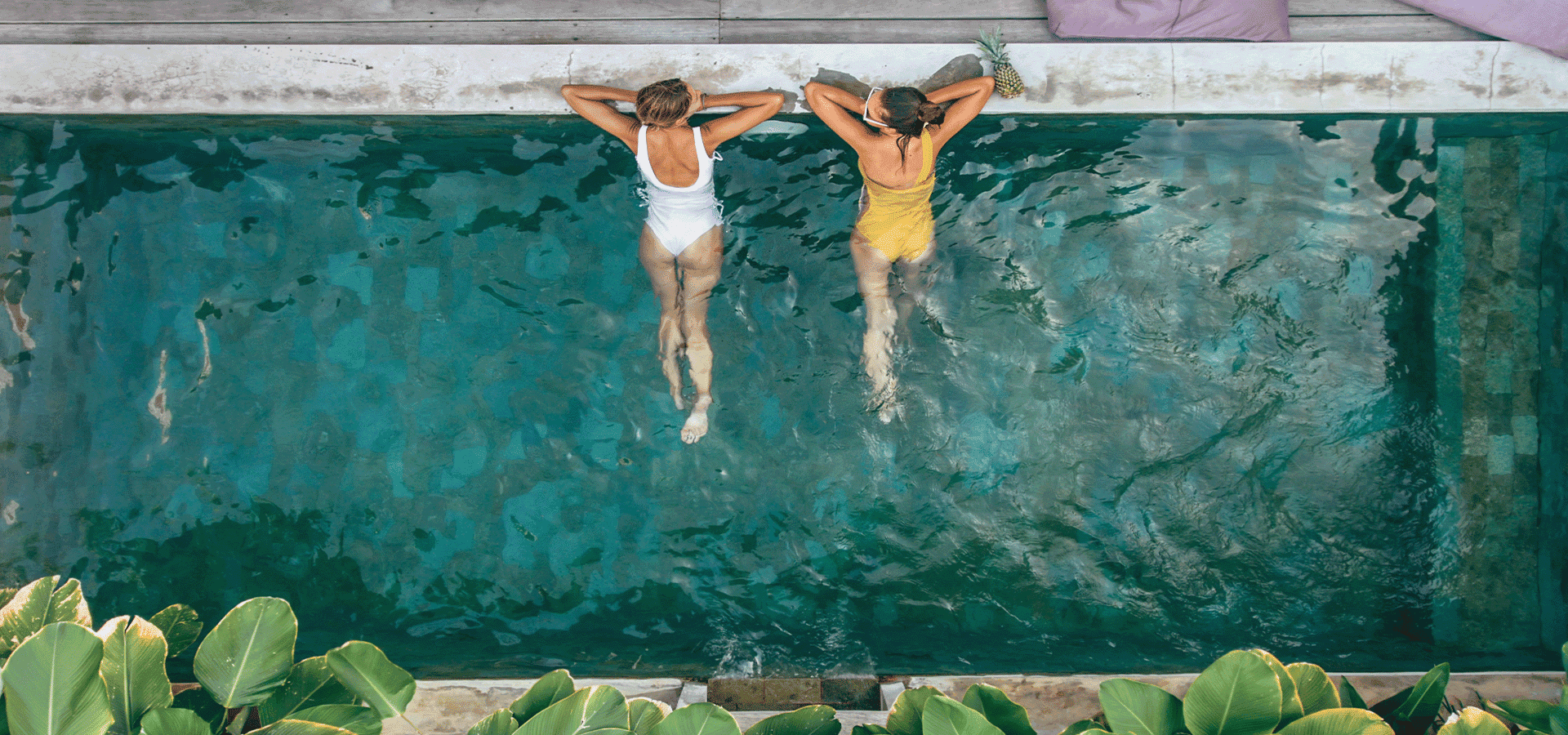 Travellers swimming in pool 