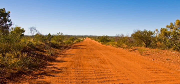 Blue Sky and red dirt road in Alice Springs