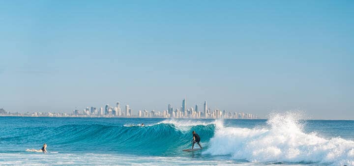 Surfing with gold coast skyline in the background