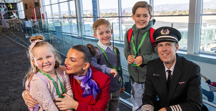 Virgin Australia cabin crew with children at airport