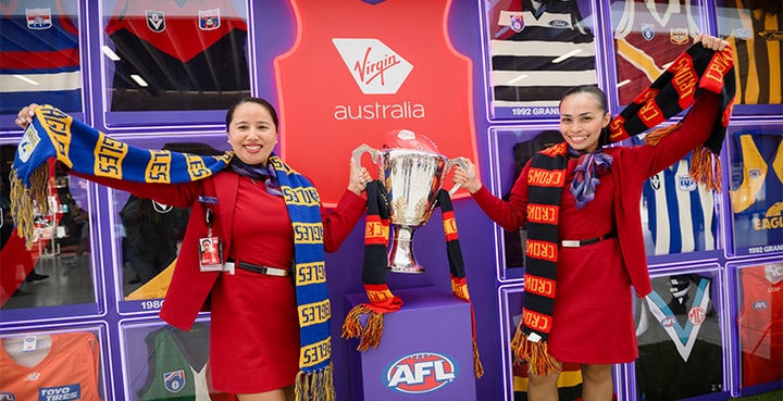 Virgin Australia cabin crew with AFL grand final trophy