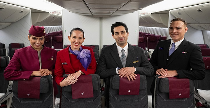 Virgin Australia and Qatar Airways cabin crew standing inside cabin of aircraft