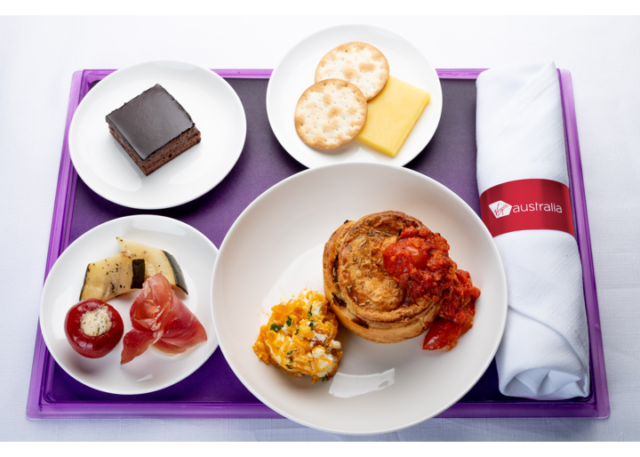 Lamb rosemary pie with side salad and dessert dishes plated up for Virgni Australia's Business Class Menu for 2021